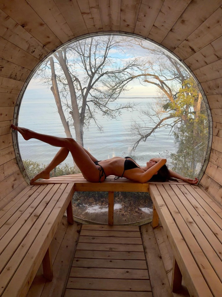 Nina inside a circular, barrel-style sauna
