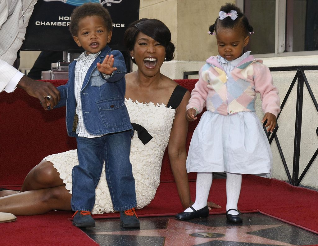 Actress Angela Bassett poses with her children Slater (L) and Bronwyn (R) beside her star on the Hollywood Walk of Fame during the star presentation ceremony, in Hollywood, California on March 20, 2008.