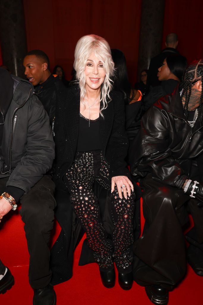 Cher in all black on front row