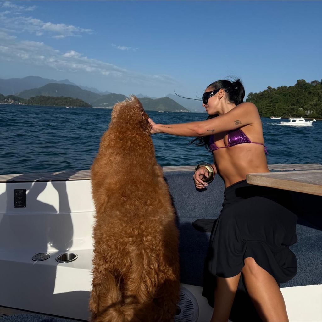 Dua Lipa with a rather large dog