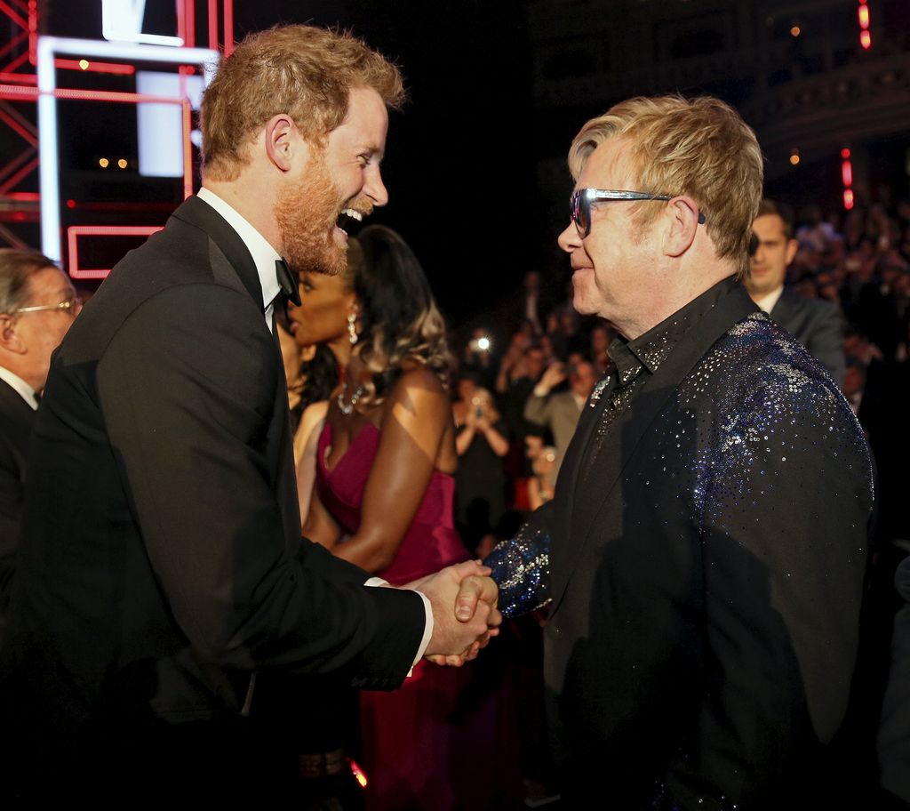 Prince Harry greets Elton John after the Royal Variety Performance at the Albert Hall on November 13, 2015 