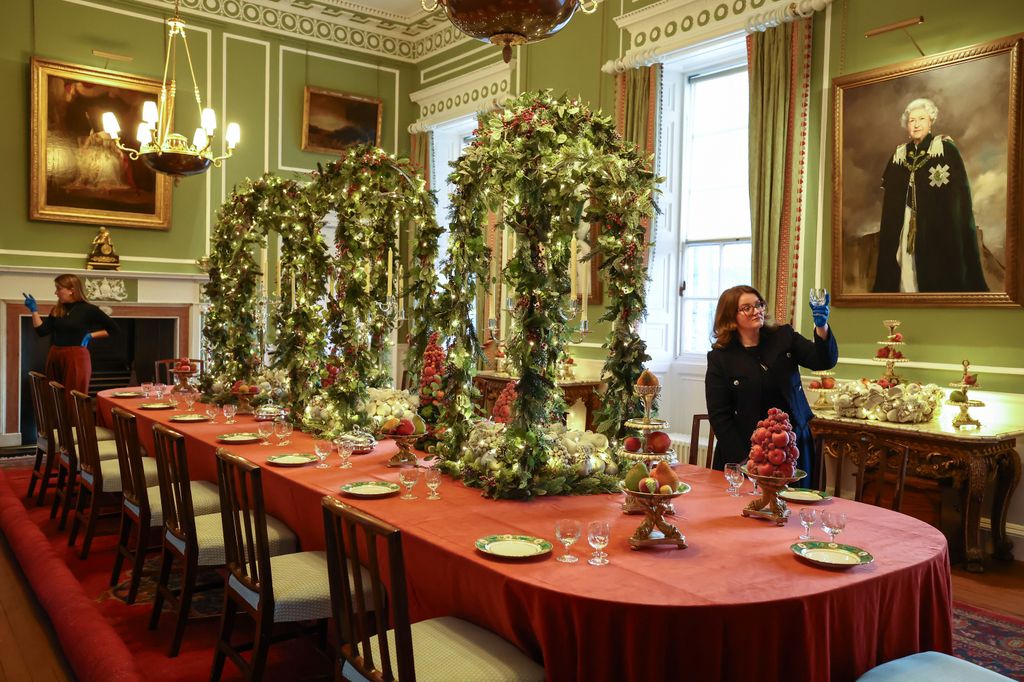 Holyroodhouse staff finish the Christmas decorations in the Royal Dining room at Holyrood Palace