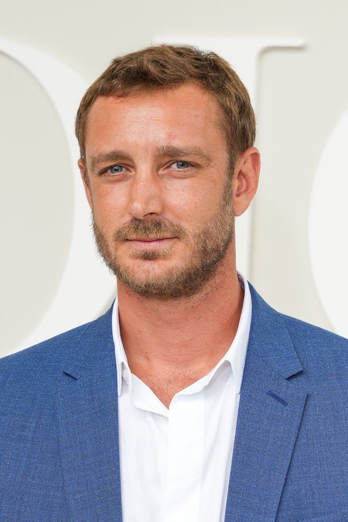 Pierre in a blue suit and white shirt 