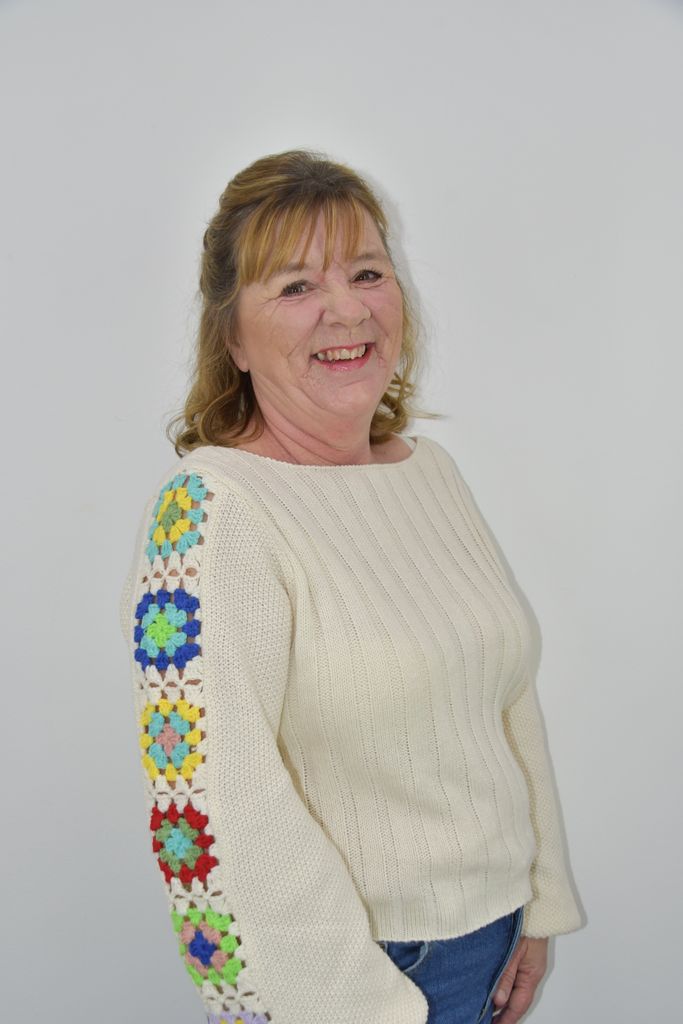 Woman smiling in a cream jumper