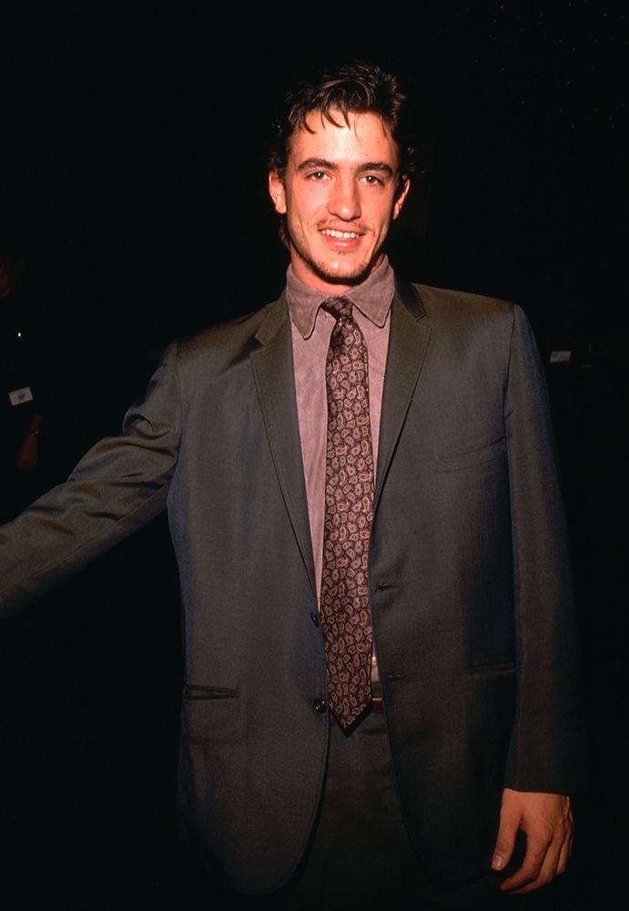 Dermot Mulroney wearing a suit in 1989. 