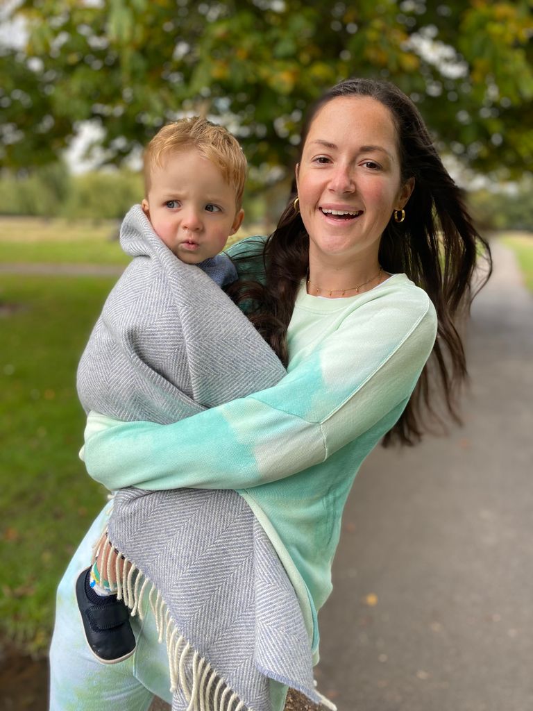 Woman carrying a baby wrapped in a blanket