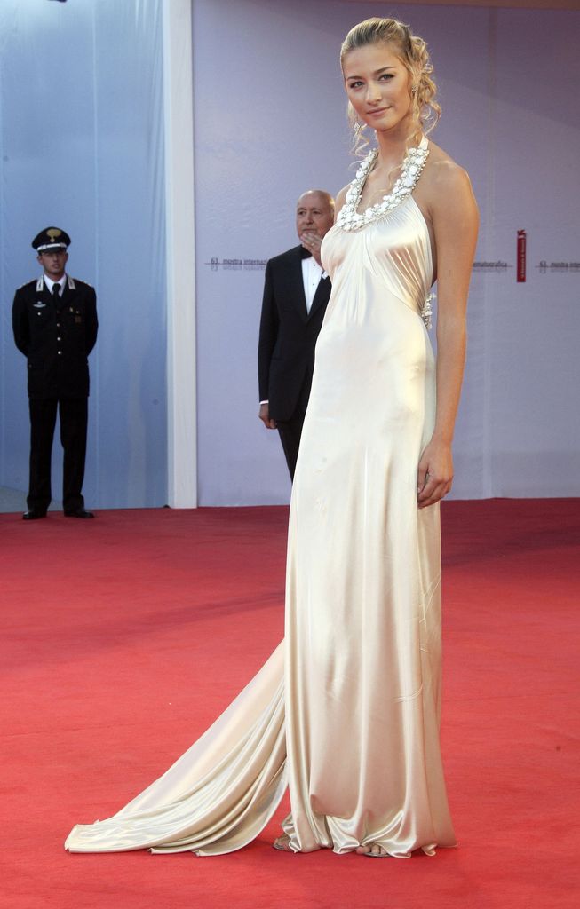Beatrice Borromeo stuns on the 2006 Venice Film Festival red carpet in a champagne satin gown with a floral halterneck, soft train and vintage-inspired curls.