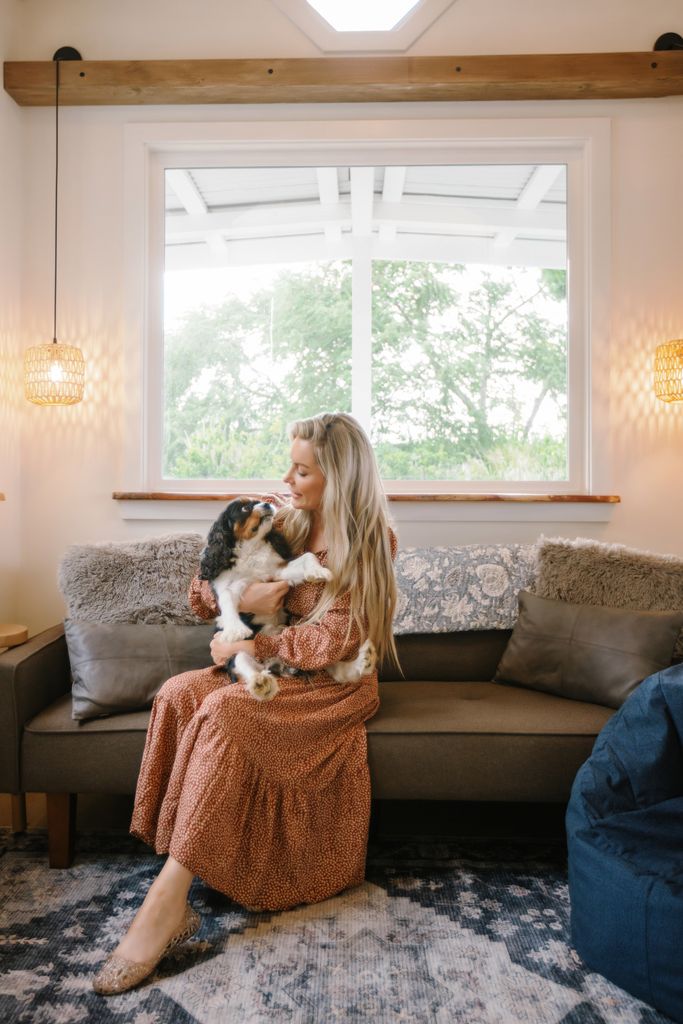 Crystal Hefner cuddles her dog in her living room
