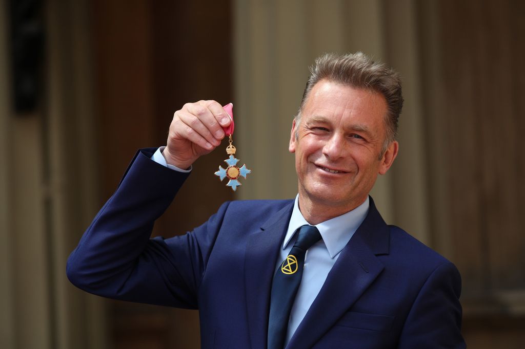 Chris Packham poses with his CBE following an investiture ceremony at Buckingham Palace on May 16, 2019 in London, England