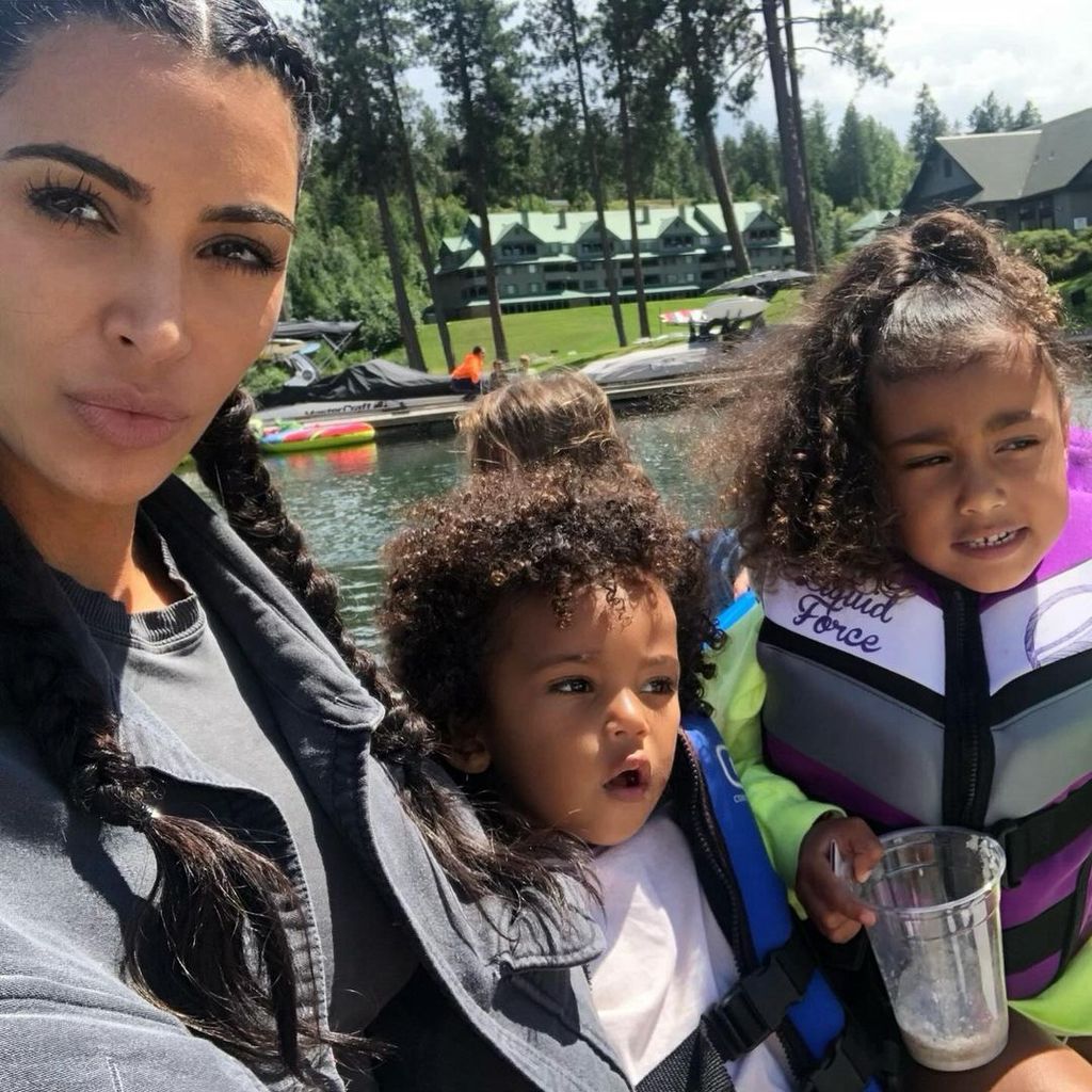 Kim with a younger North West and Saint by the lake