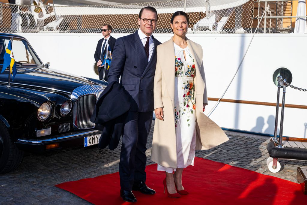 Crown Princess Victoria on red carpet by yacht with husband