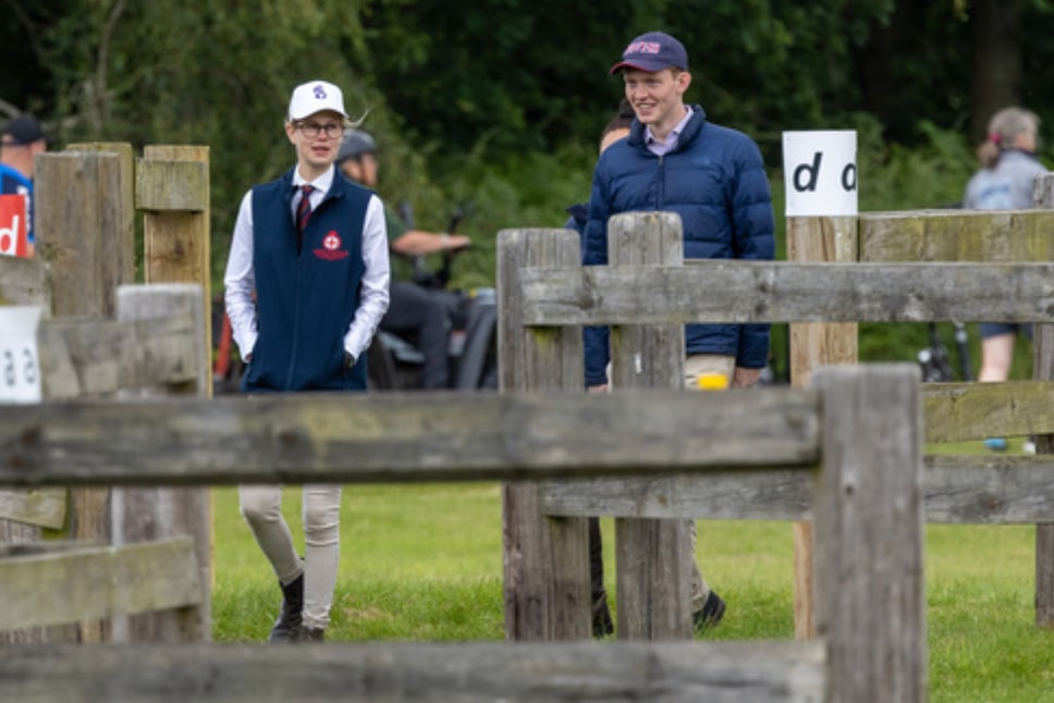 Lady Louise Windsor walking through a field with Felix da Silva-Clamp