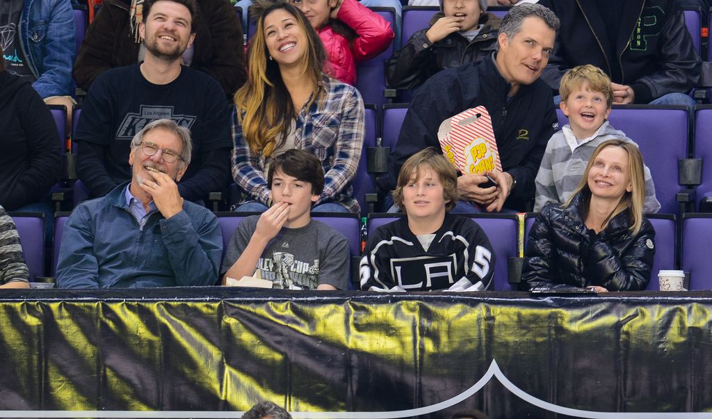 Harrison Ford, Liam Flockhart and Calista Flockhart attend a hockey game between the Carolina Hurricanes and the Los Angeles Kings at Staples Center on March 1, 2014 in Los Angeles, California