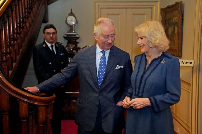 king charles and camilla looking at each other and smiling 