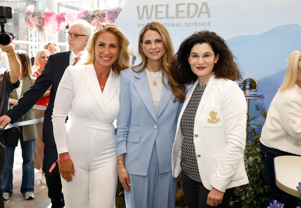Princess Madeleine in a blue suit with two women in white suits