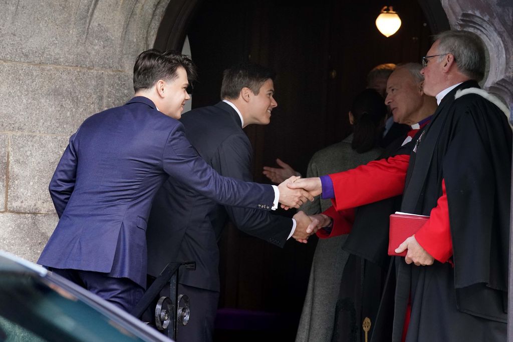 Samuel and Arthur Chatto shaking hands with the priest as they arrive at church