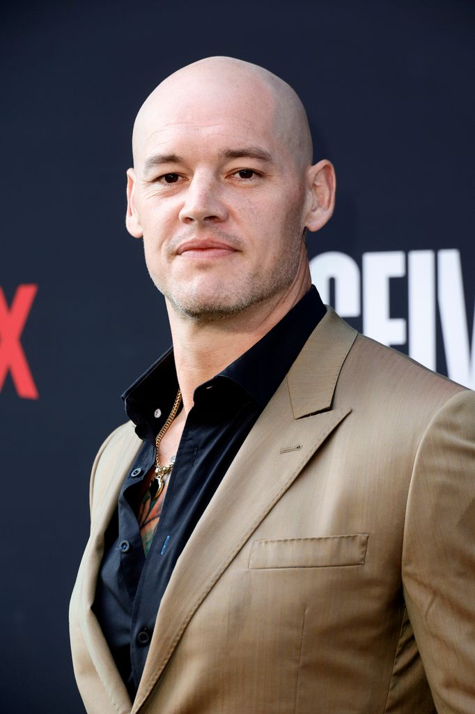 baron corbin in beige suit and black shirt for netflix premiere