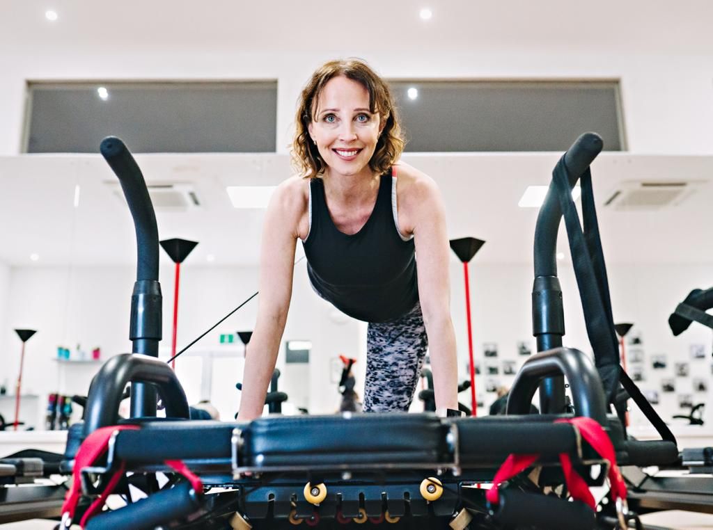 Woman on a megaformer Pilates machine 