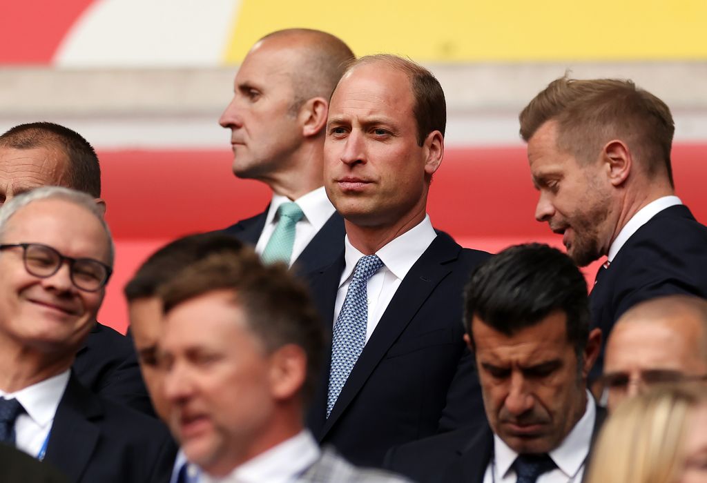 Prince William in a suit with a group of people