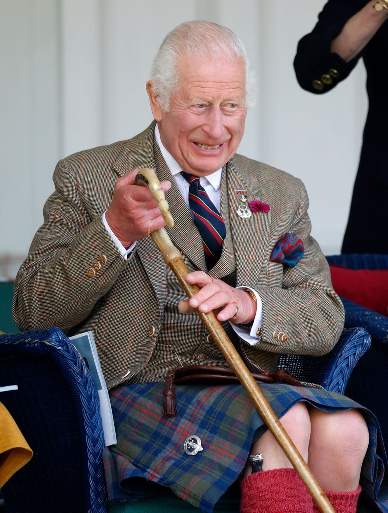 King Charles giggling with a walking stick in 2024