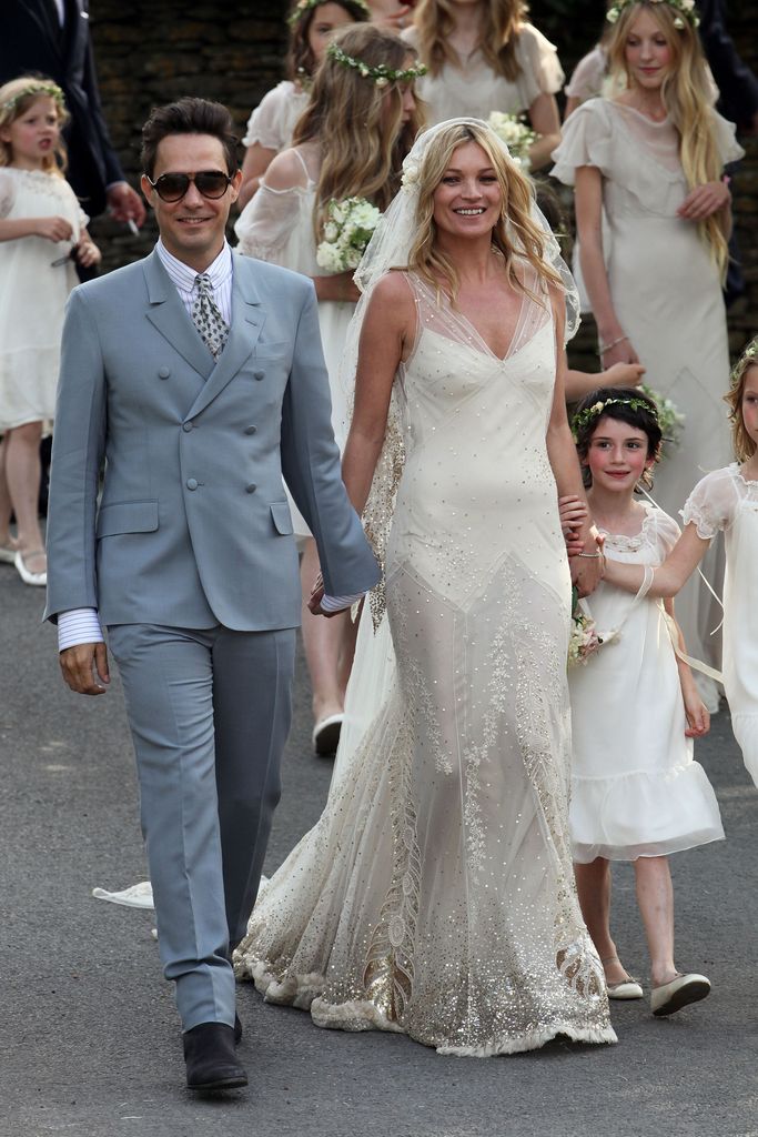 Kate Moss and Jamie Hince walk outside the church after getting married on July 1, 2011