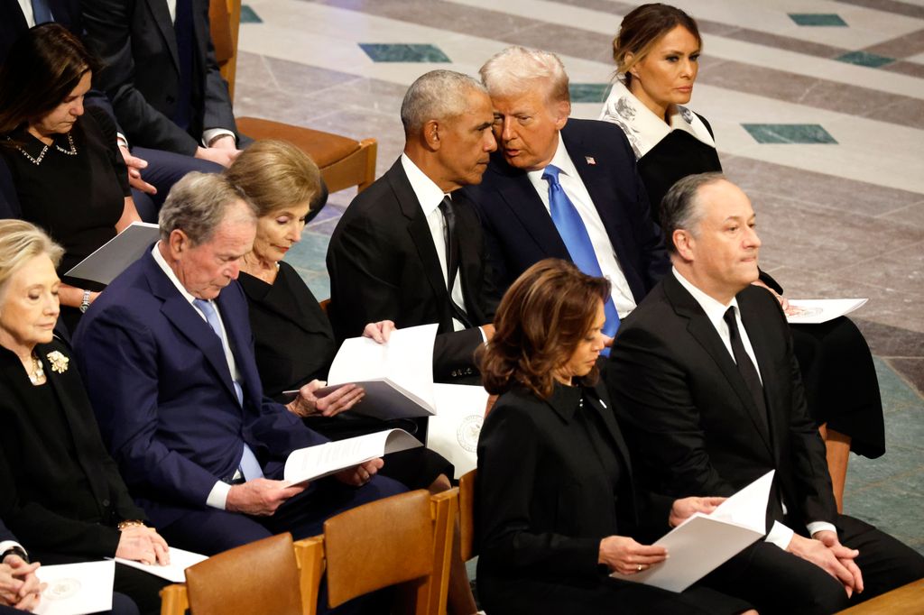 U.S. President-elect Donald Trump speaks with former U.S. President Barack Obama during the state funeral for former U.S. President Jimmy Carter 