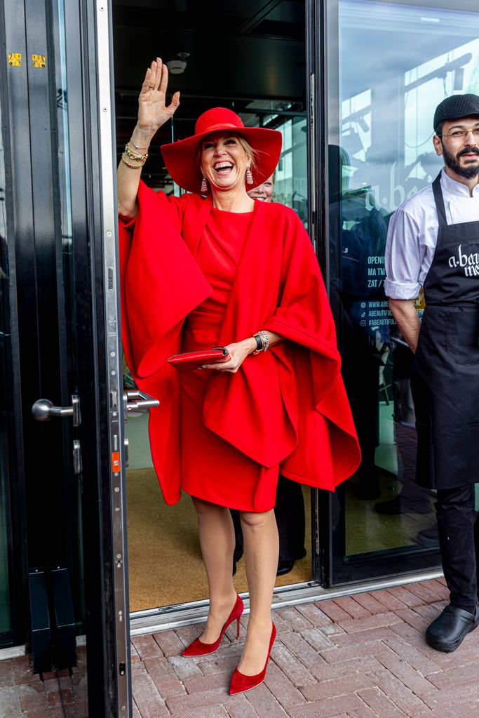 Queen Maxima waving in red dress and hat