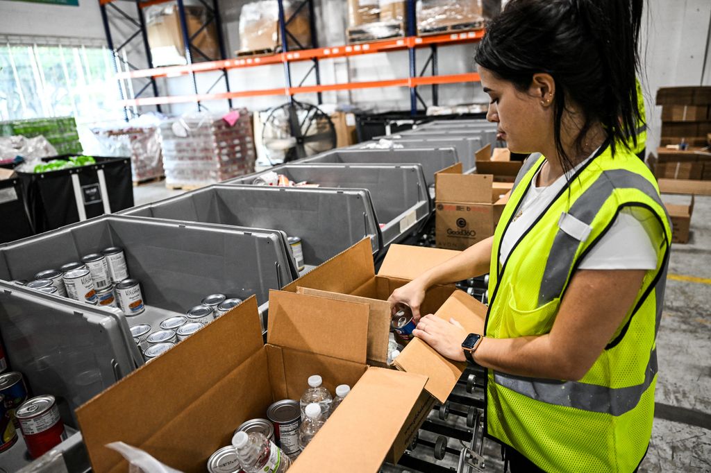 Volunteers assemble relief packages for Hurricane Melissa at the Global Empowerment Mission headquarters in Miami, Florida