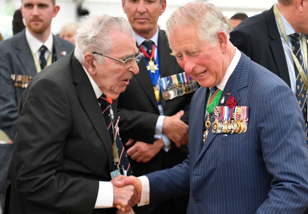 A war veteran shaking the hand of King Charles