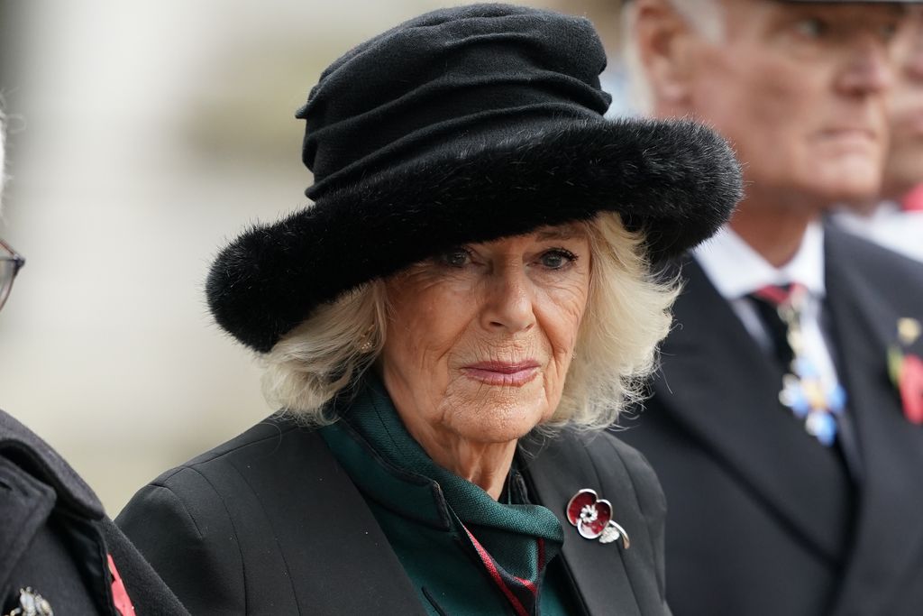 Queen Camilla in a fur hat and black cape