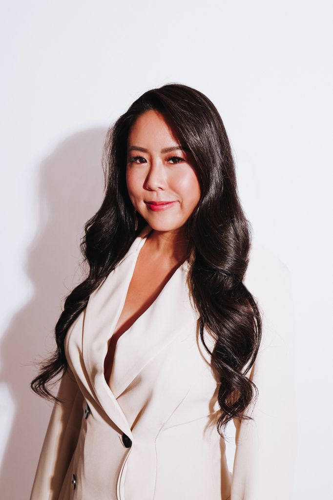 woman in white blazer with long dark hair