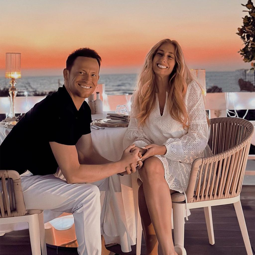 Stacey Solomon and Joe Swash hold hands as they have a romantic dinner