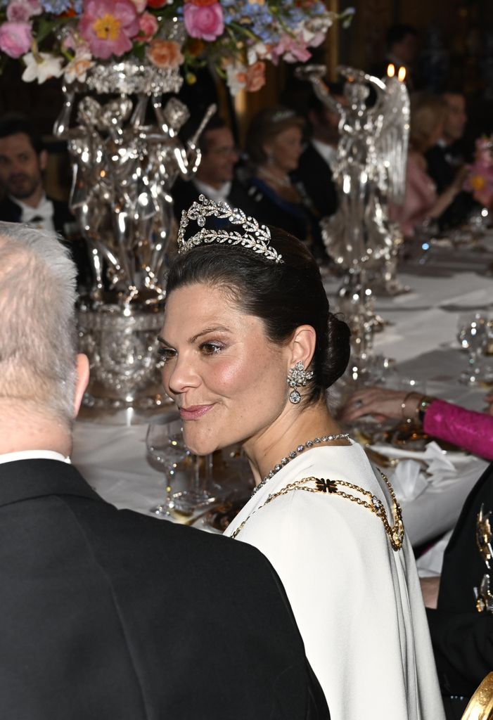 Crown Princess Victoria talking at banquet in a pair of diamond earrings to match her diamond tiara