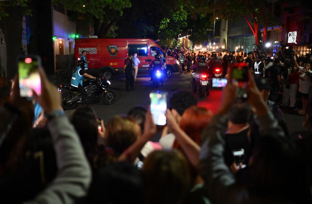 Forensic workers take the body of Liam Payne on a fire van from the hotel where he died in Buenos Aires