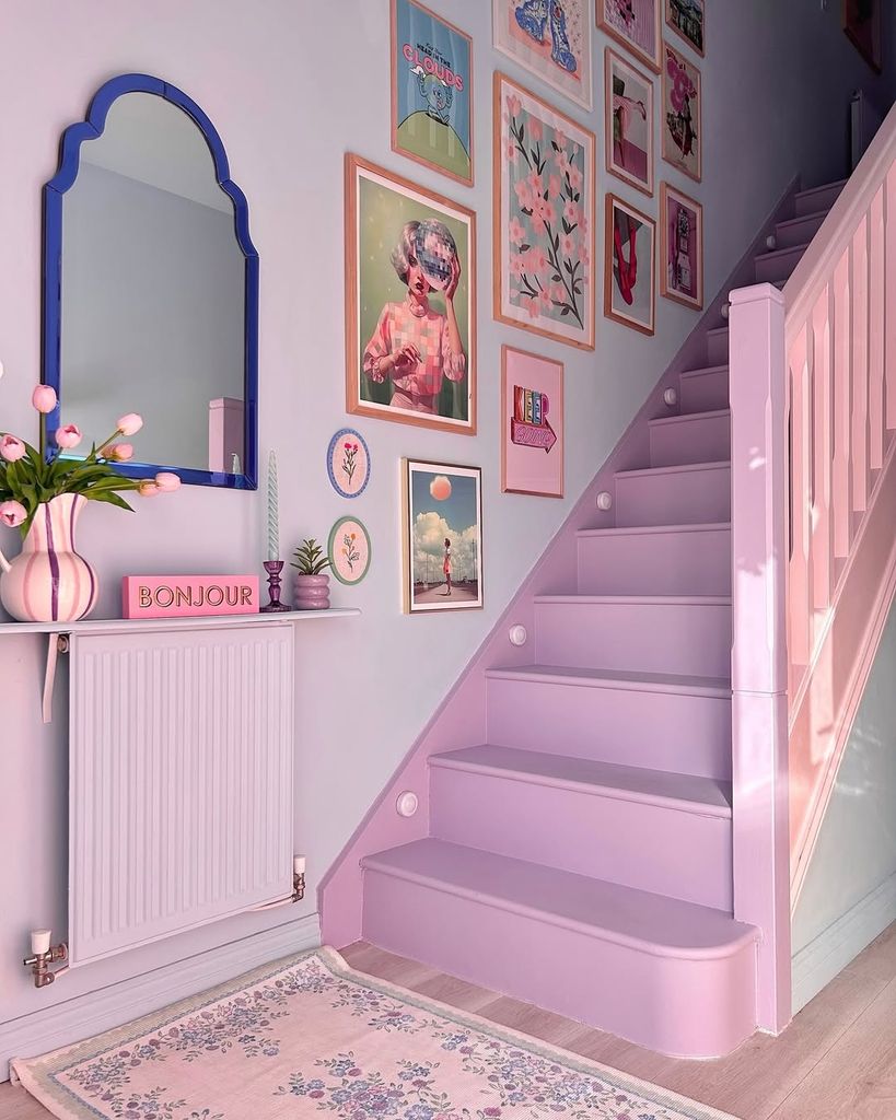 purple stairs in hallway with lots of photoframes