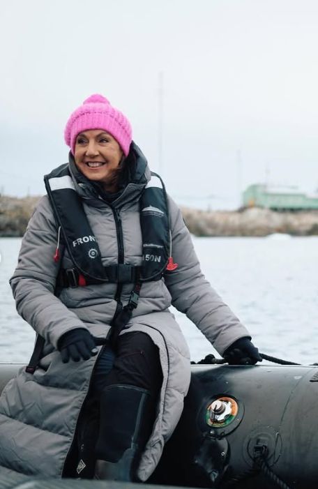 Jane McDonald in a grey parka coat, pink bobble hat and life preserver