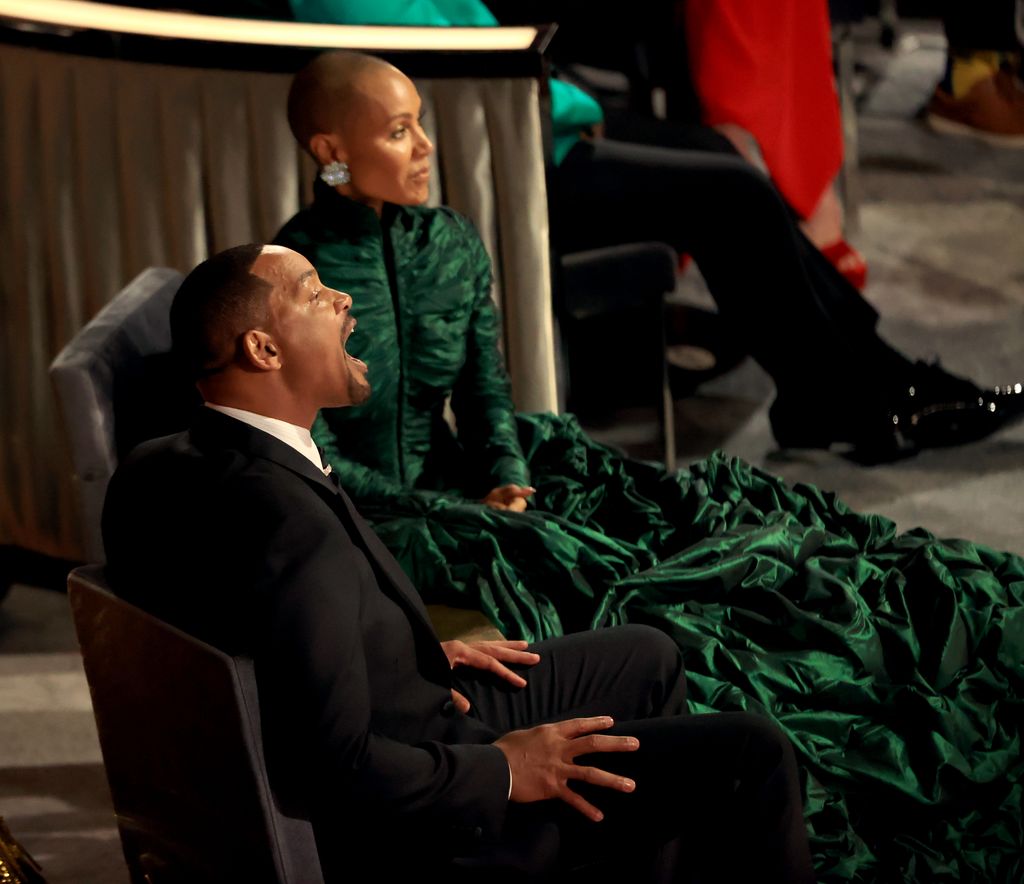Jada Pinkett Smith sits as Will Smith screams at Chris Rock during 2022 Oscar broadcast