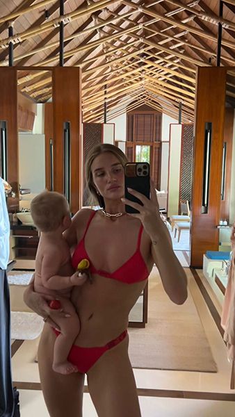 rosie huntington whiteley wearing red bikini posing with daughter