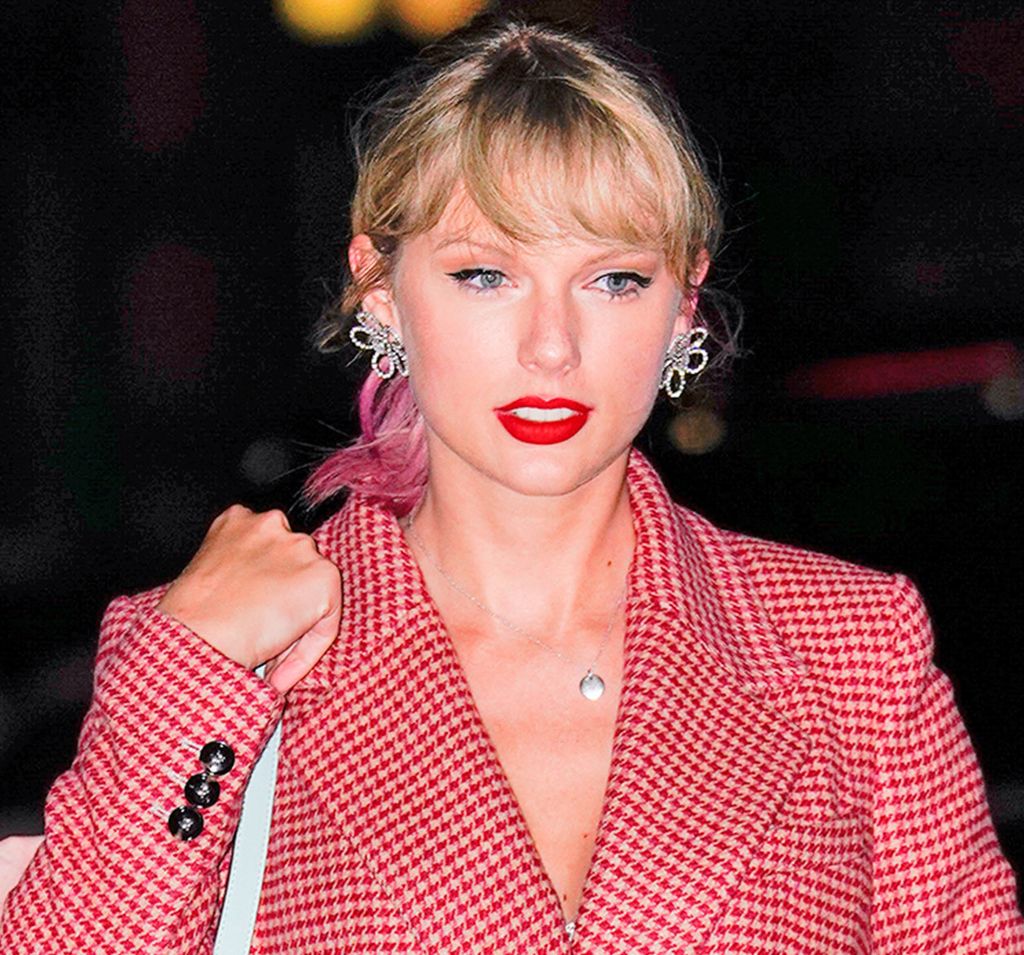 Taylor Swift in a red check jacket and red lipstick