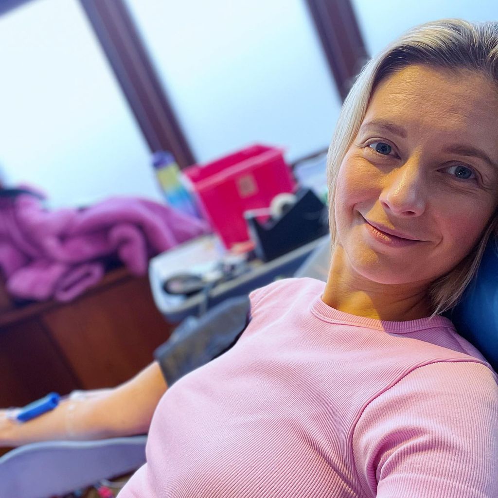Rachel Riley giving blood in a pink top