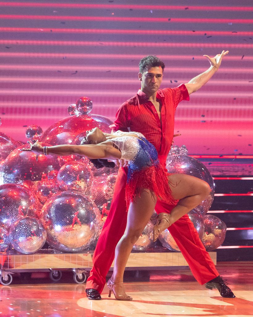 Ezra Sosa dancing with partner in red shirt and pants