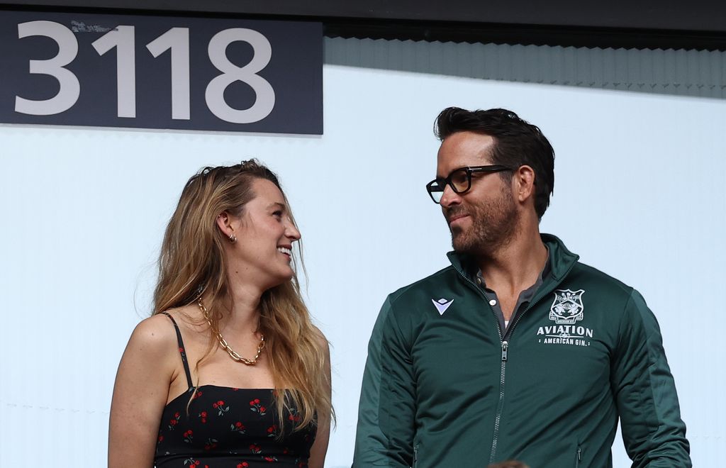 Blake Lively and Ryan Reynolds gazing at each other at a Wrexham game