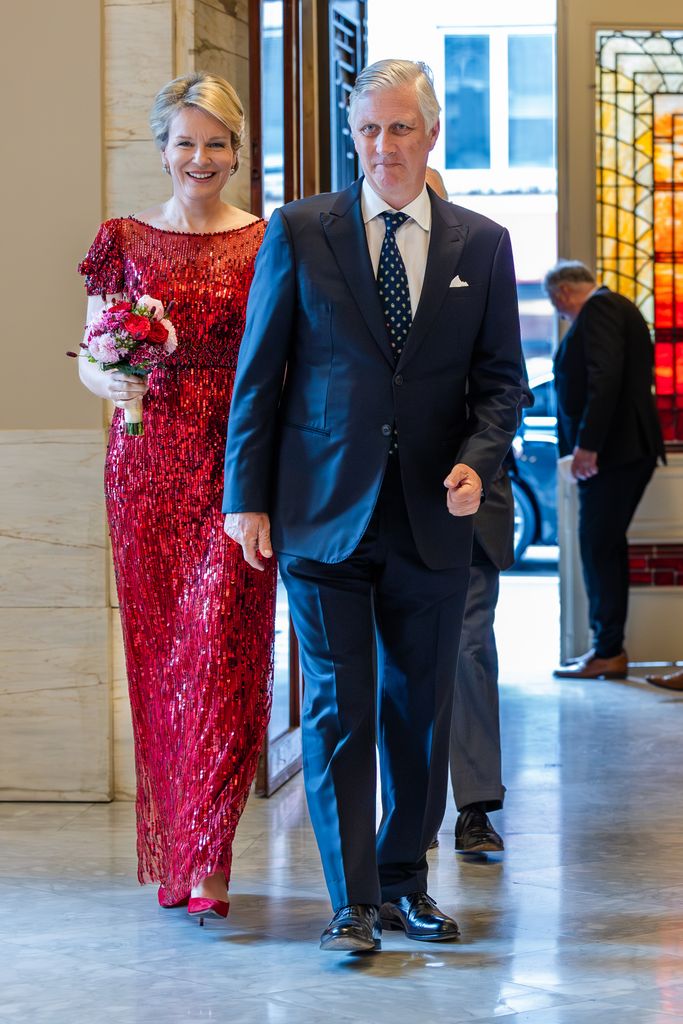 Queen Mathilde in a red sequin dress with her husband