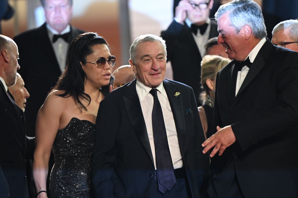 Tiffany Chen and Robert De Niro depart the "Killers Of The Flower Moon" red carpet 
