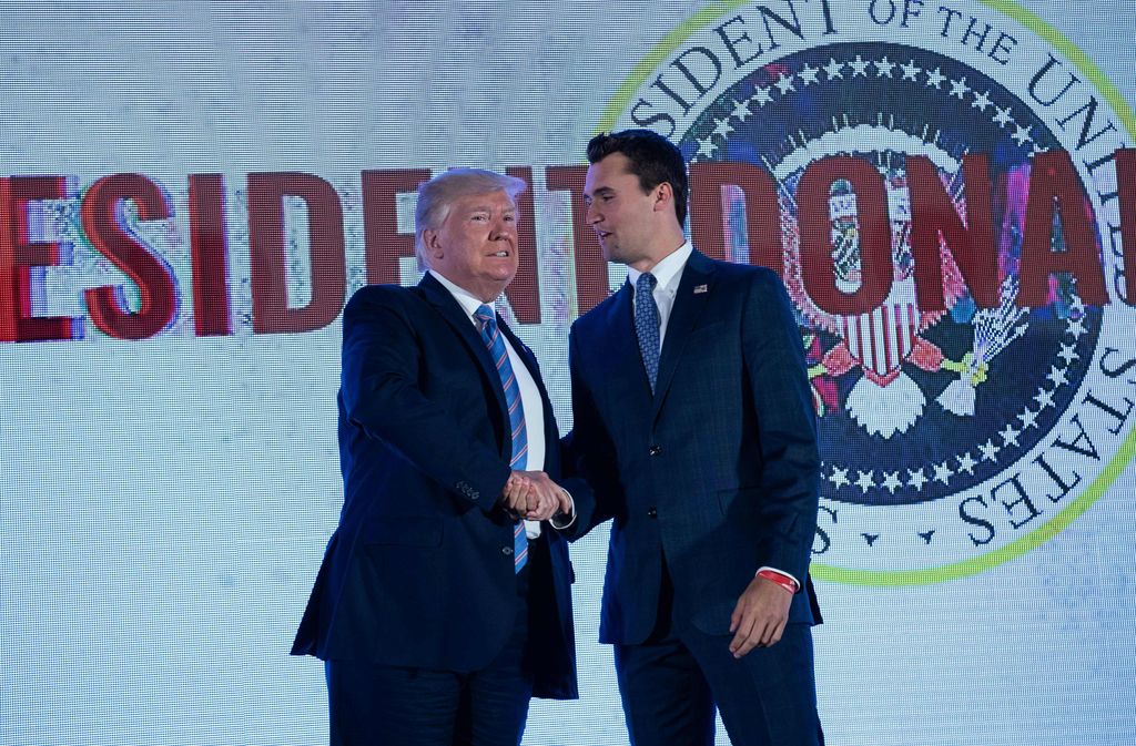 US President Donald Trump shakes hands with Charlie Kirk, head of Turning Point USA, before addressing the Turning Point USAs Teen Student Action Summit in Washington, DC, on July 23, 2019