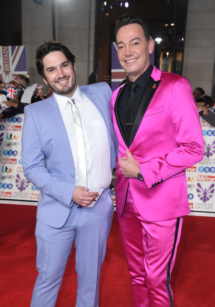 Jonathan Myring in a blue suit and Craig Revel Horwood in a pink suit