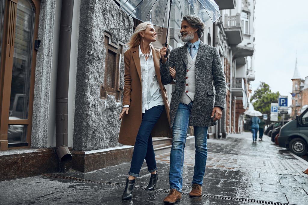 happy couple dressed alike walking in city.
