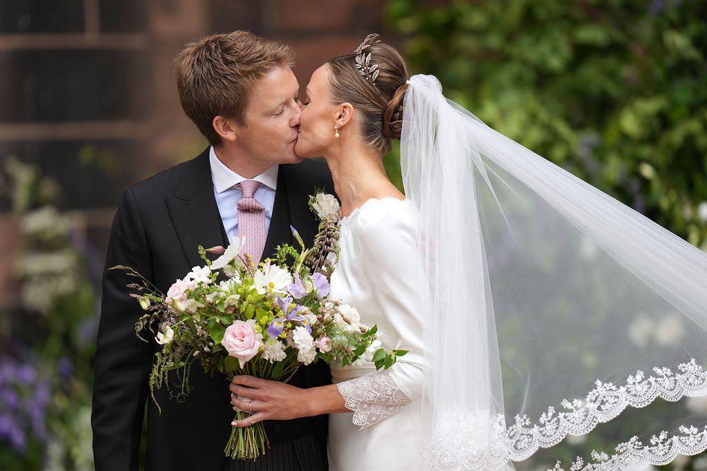 Hugh and Olivia kiss after their wedding
