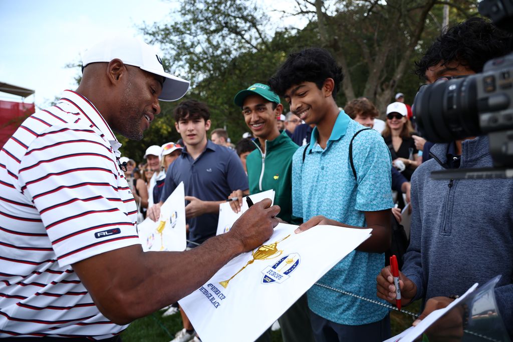 Former NFL player Michael Strahan signs autographs near the second tee prior to the Ryder Cup 2025 at Black Course at Bethpage State Park Golf Course on September 24, 2025 in Farmingdale, New York