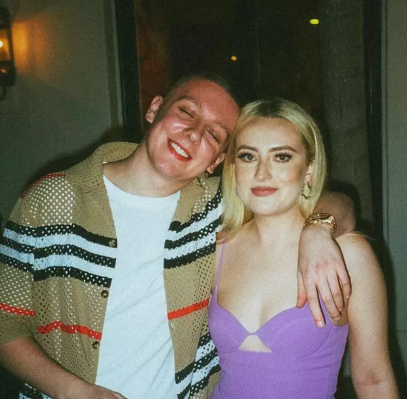 Aitch with his arm around Amelia Dimoldenberg